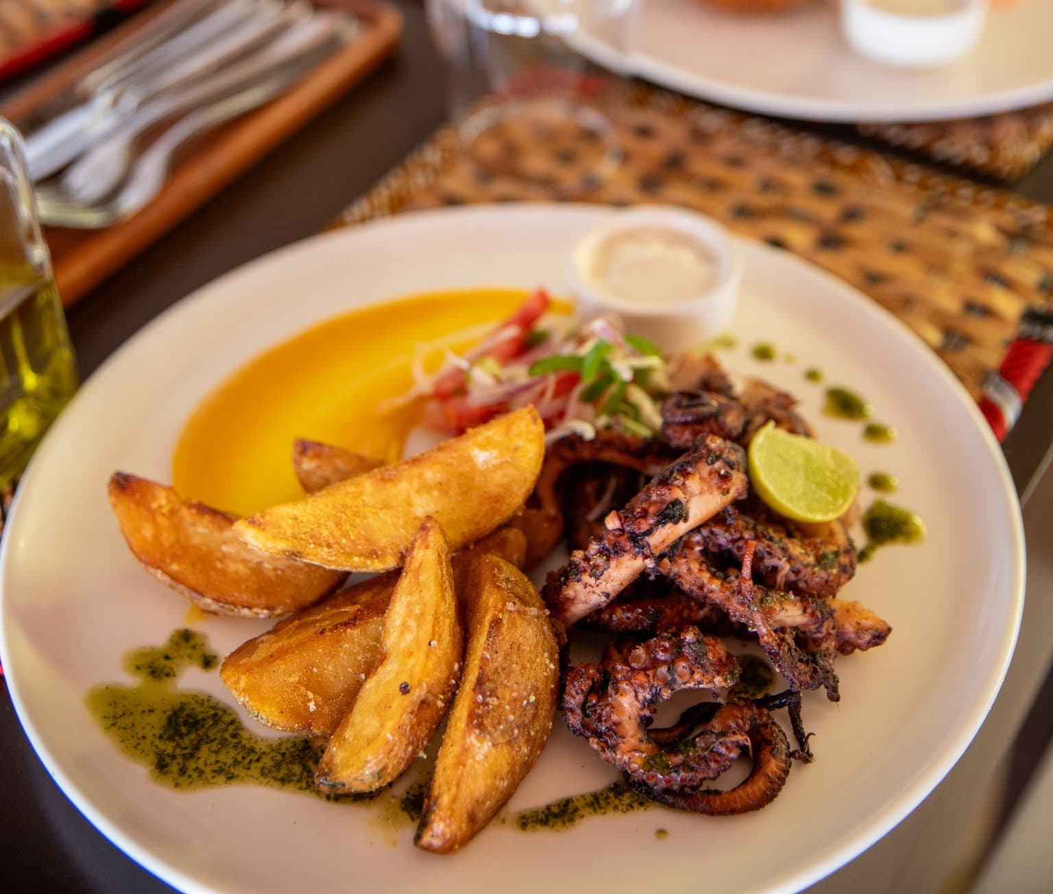 Chips and grilled octopus dish at Veridiana Hotel's restaurant