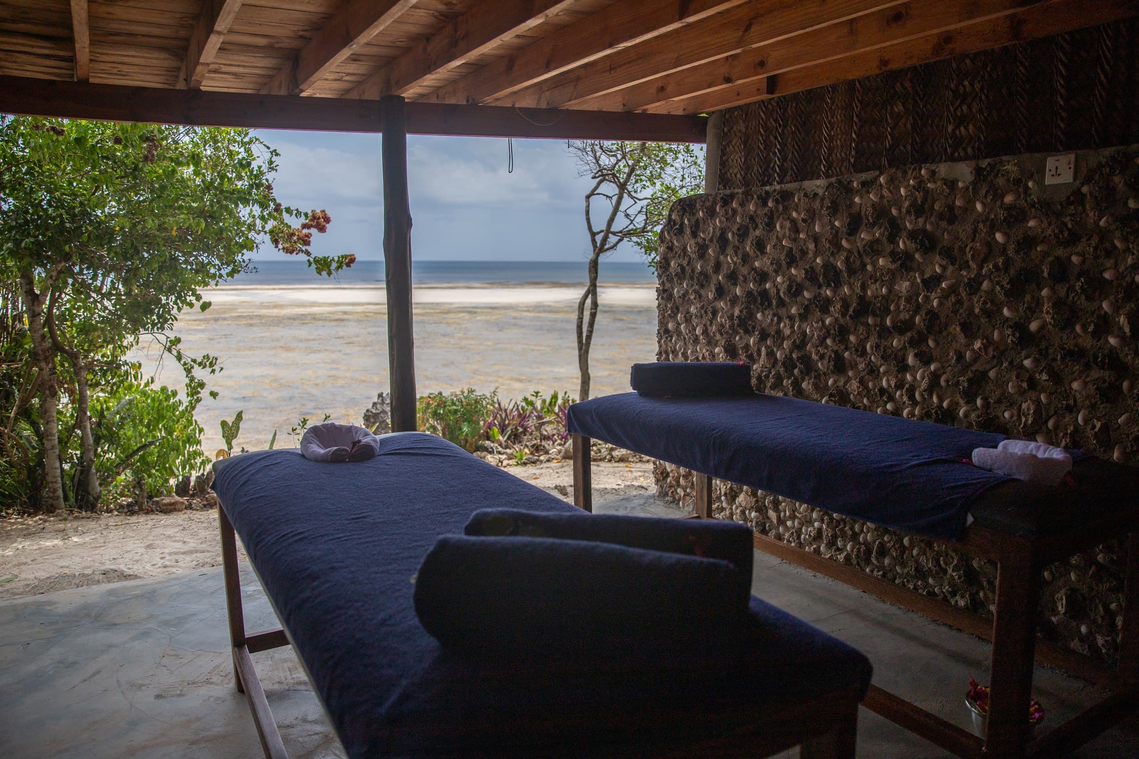 Outdoor massage beds overlooking the ocean at Veridiana Hotel Zanzibar